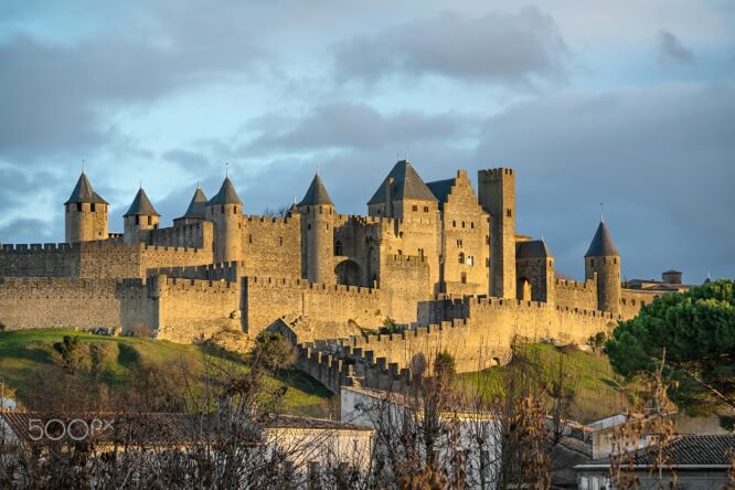 Walls and towers of Carcassonne in light of setting sun