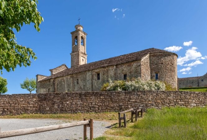 Old parish church under blue sky in town of Prunetto