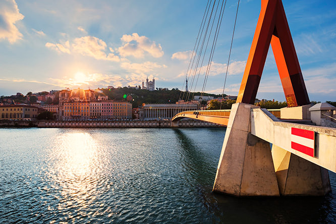 Cloudy sunset over Vieux Lyon and Fourviere Basilica seen from the riverbank of the Saone