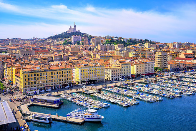 The old Vieux Port and Basilica Notre Dame de la Garde in the historical city center of Marseille