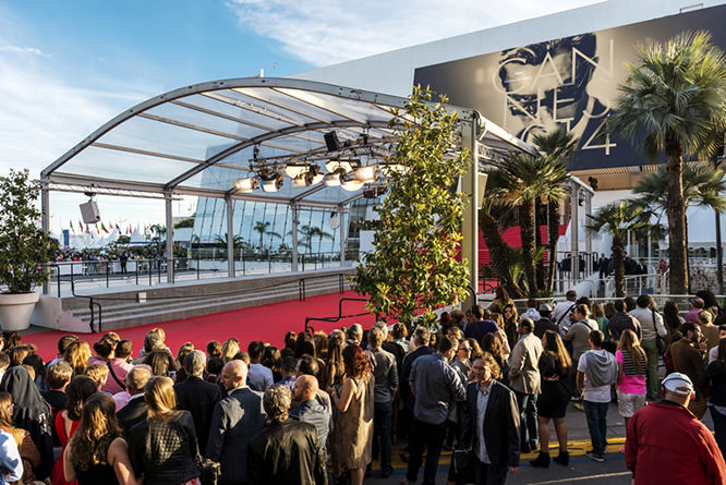 Great Auditorium of the exit door at Cannes, the famous red carpeted stairs and crowd of people waiting at the gate output