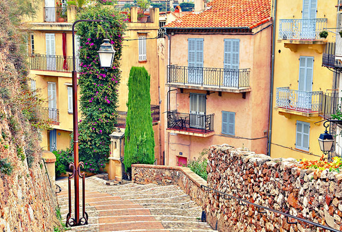 Street with buildings and paved brick walkway in Cannes
