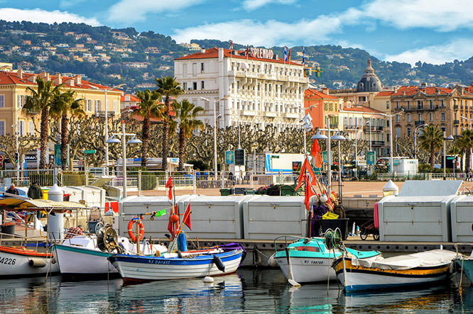 Street with buildings and paved brick walkway in Cannes