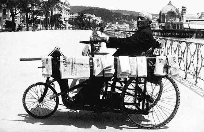 Man selling newspapers around 1930