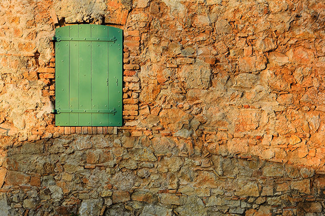An old locked window in the famous Ile Sainte Marguerite Island Jail