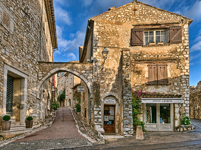 Rising sun illuminating the tops of the buildings in Saint-Paul-de-Vence, French Riviera