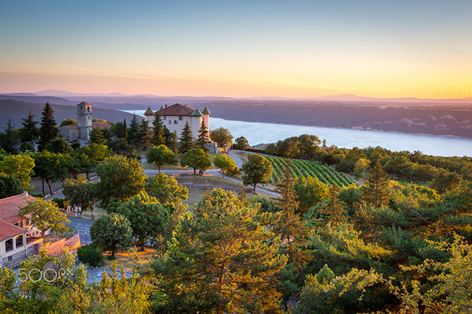 View of Aiguines village with charming chateau and church overlooking Lac de Sainte Croix