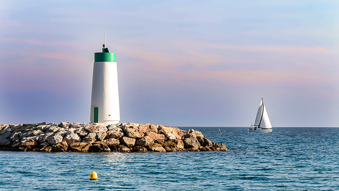 Lighthouse and sailboat French Riviera